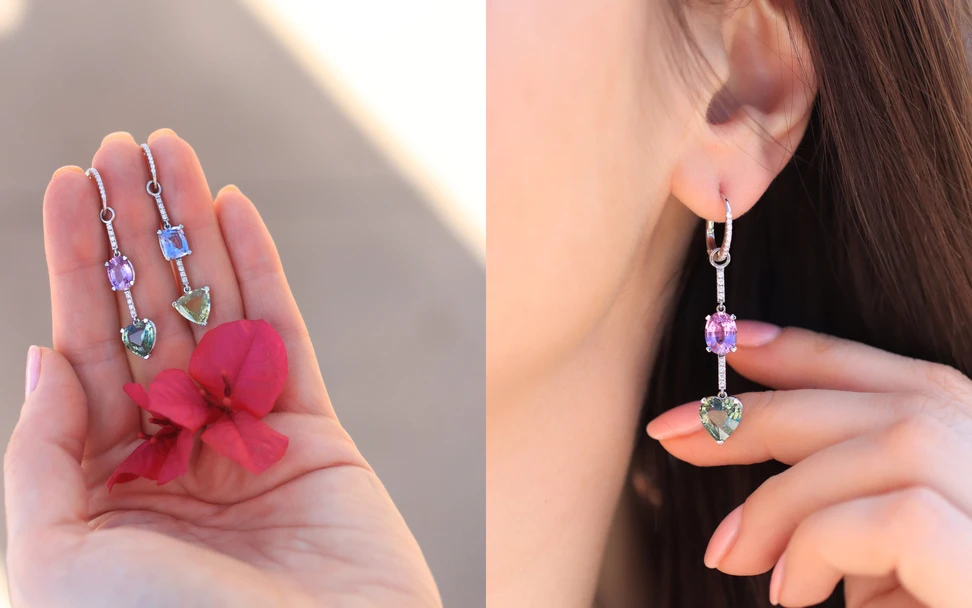 <p>A pair of earrings from the Lisa Nik Asymmetric collection with pastel-hued sapphires in shades of pink, blue and green on a stem of pavé diamonds</p>

