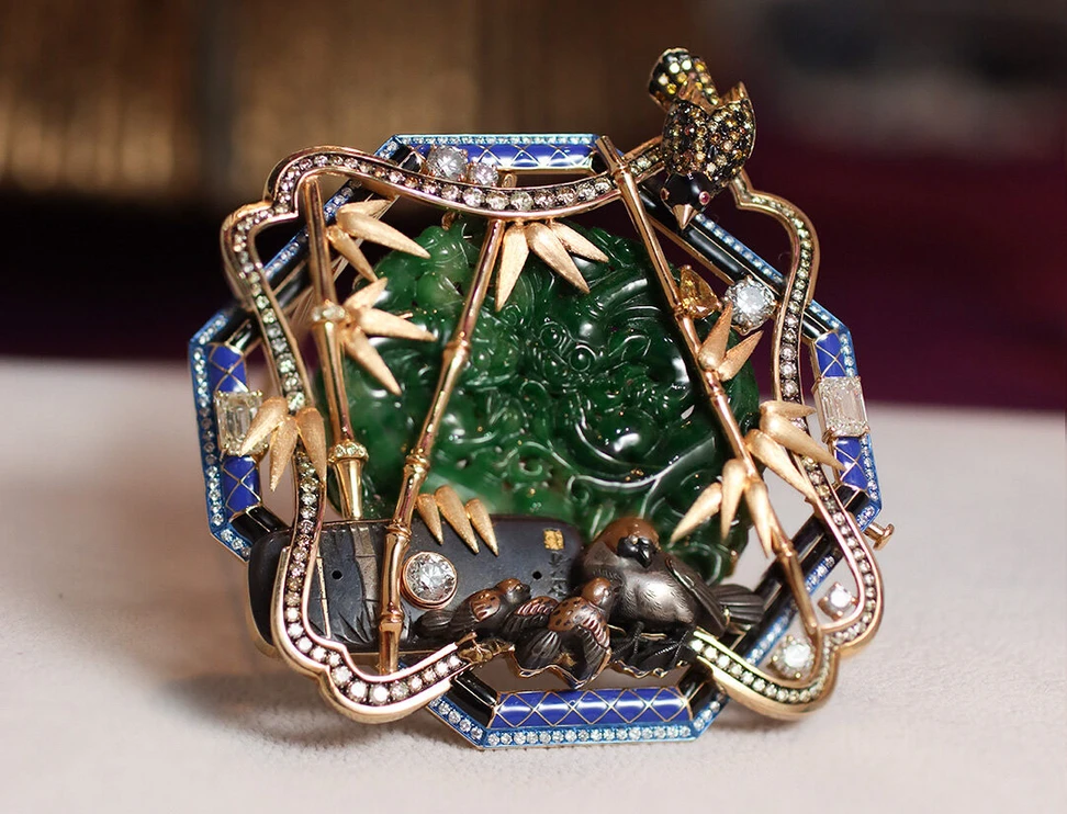 <p>Austy Lee The Ryuzen Garden brooch from The Ancient Fetus collection with a Meiji antique Samurai Menuki, Burmese green jades, blue and black enamel, rubies and diamonds set in 18k yellow gold </p>