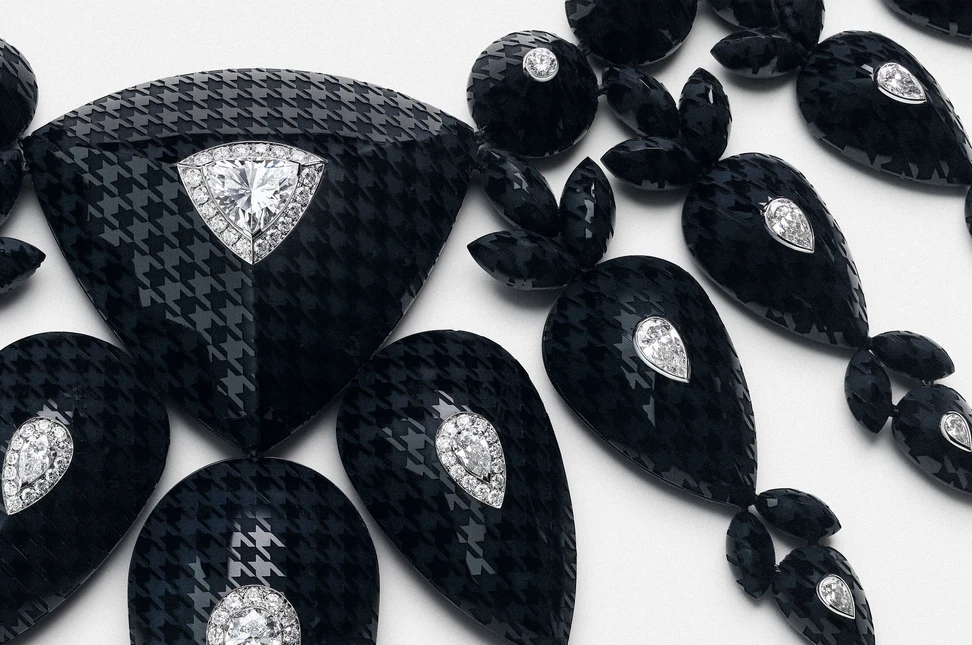 Graphic contrasts and laser-engraved houndstooth motifs define the distinctive composition of Boucheron's Checkers necklace.