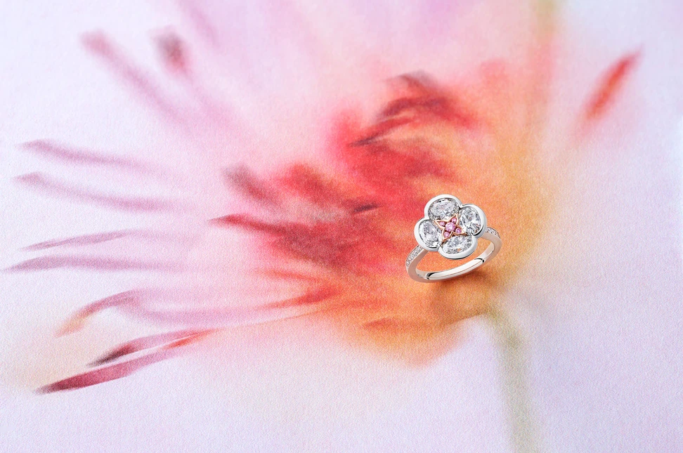 Boodles’ Posie ring translates Olwen’s mythical trail of white flowers into four white diamond petals, centred with exceptionally rare Argyle pink diamonds.