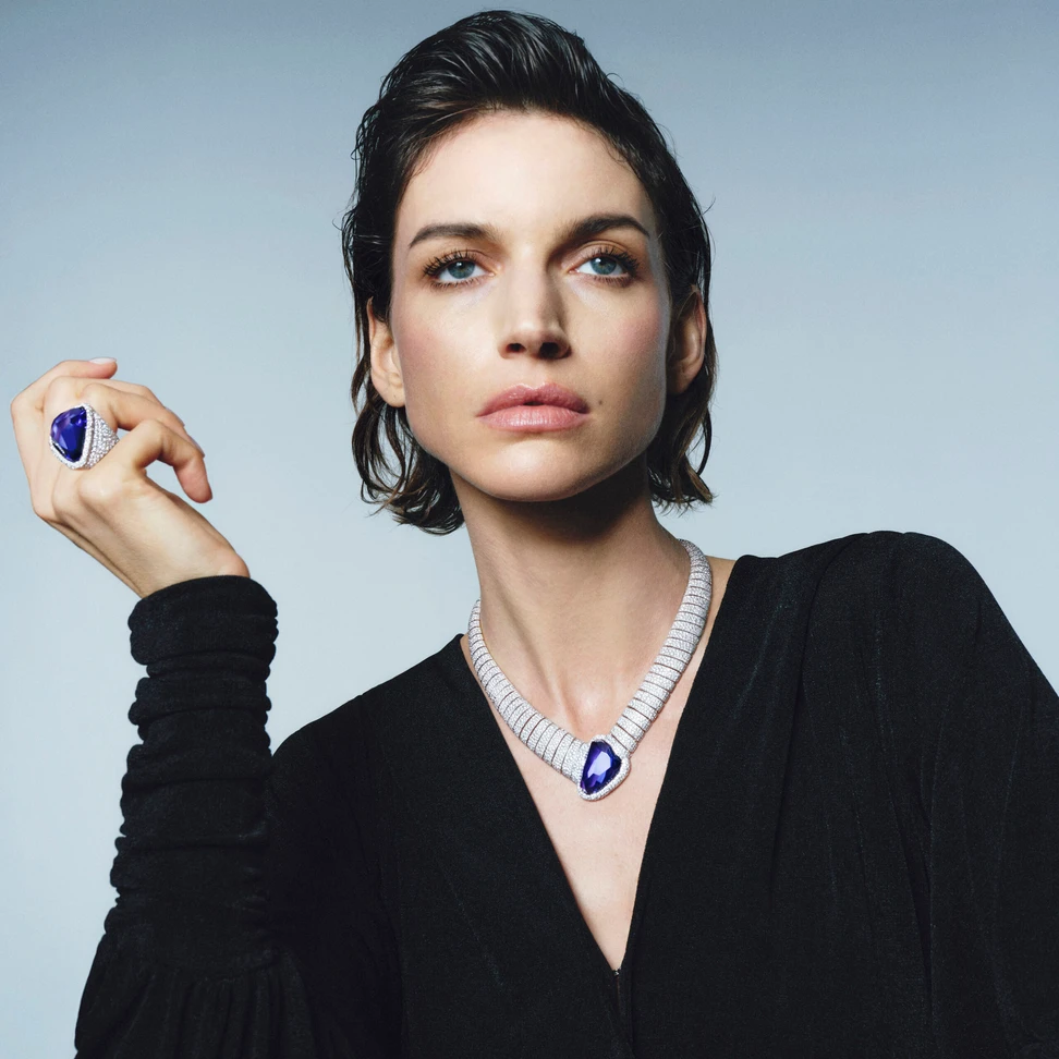 <p>A model wears the Pomellato Asimmetrico Tanzanite necklace with an irregularly cut 55.96-carat tanzanite and the matching ring with a 37.73-carat tanzanite, part of the ‘Collezione 1967’ High Jewellery collection</p>