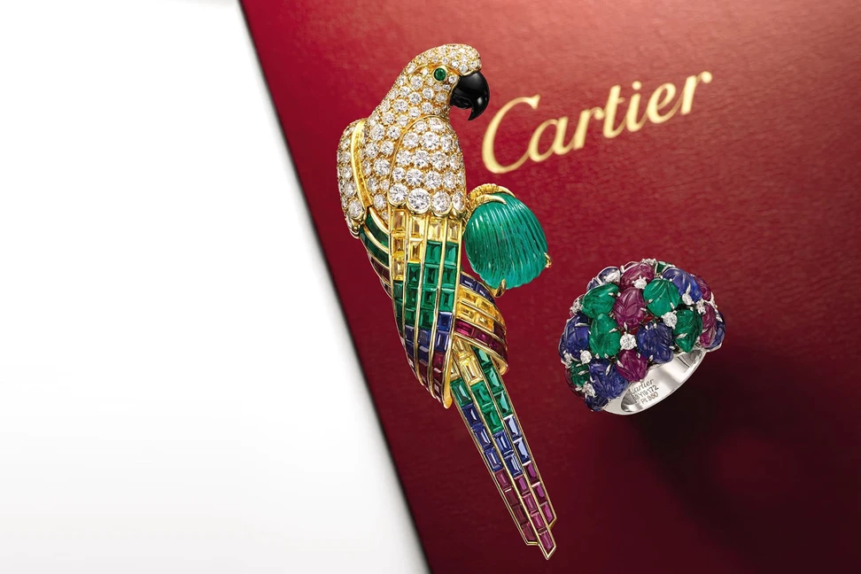 <p>Cartier Tutti Frutti inspired parrot brooch and carved gemstone ring sold by Sotheby’s</p>