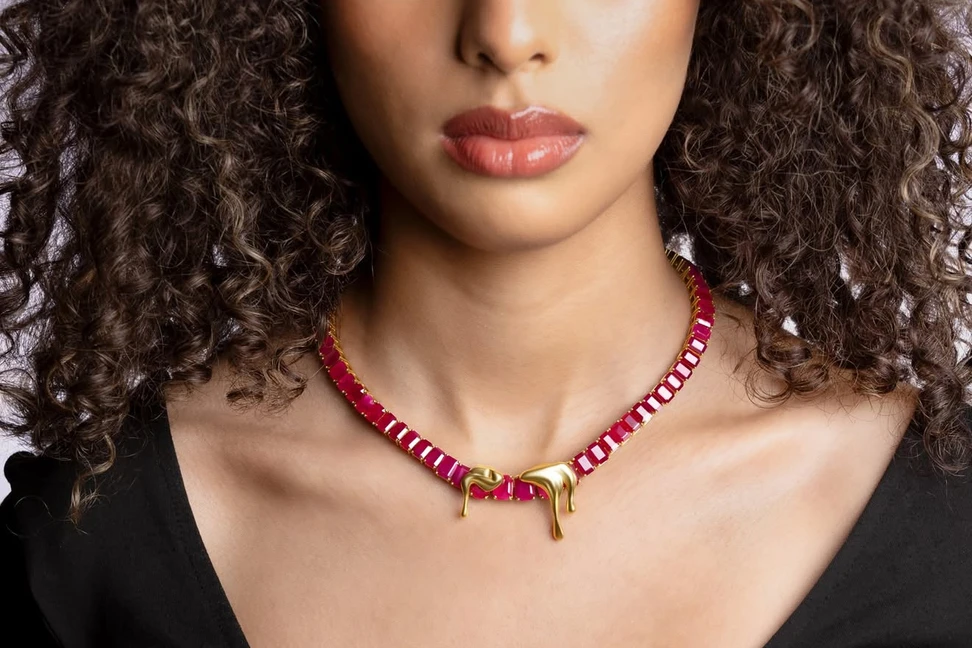 <p>Moody Jewellery 1064 pendants in 18k yellow gold, held by a ruby necklace. The collection is named after the melting point of gold</p>