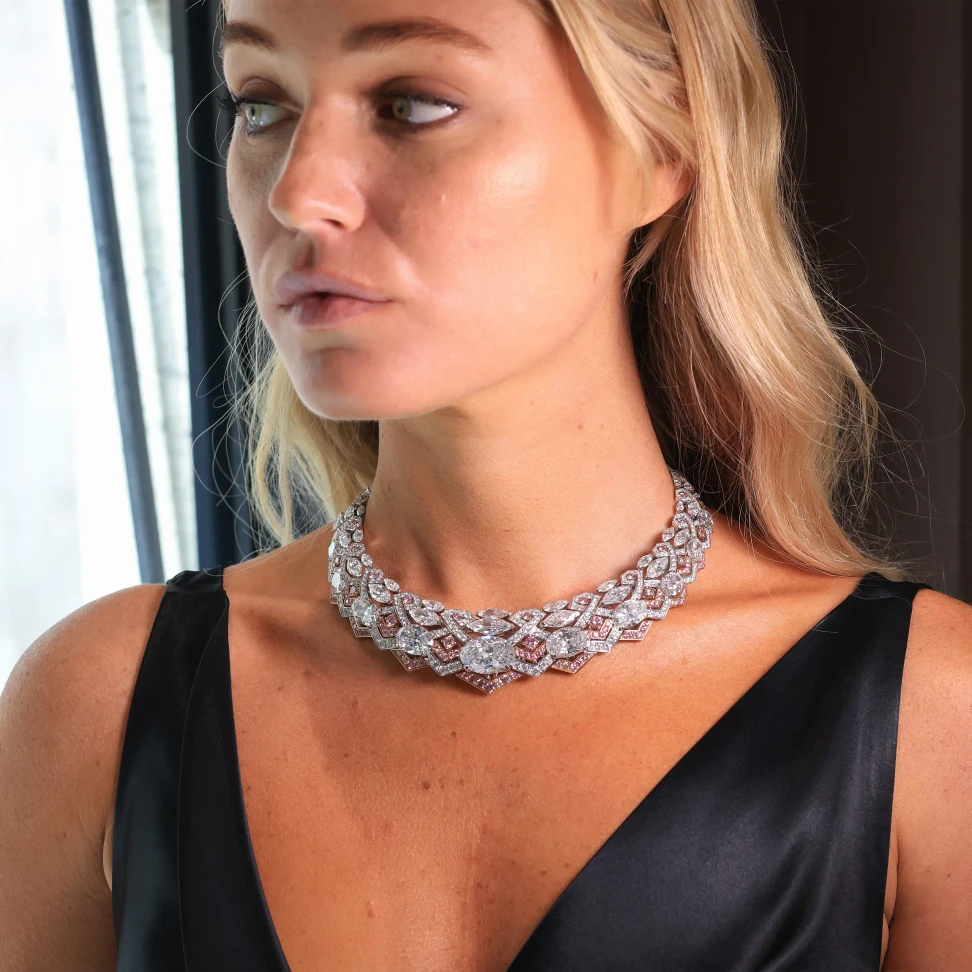 The Artemis necklace wraps the neck in sweeping chevrons of white and fancy pink diamonds, inspired by the bow and arrow of the Greek goddess
