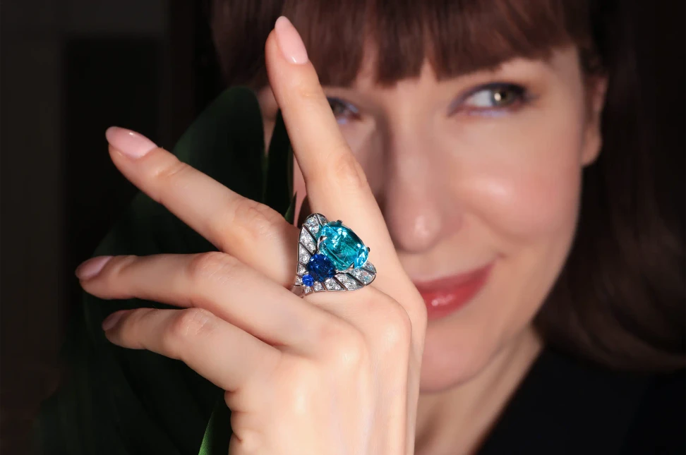 Katerina wears the Indico ring from David Morris' Legacy of Colour high jewellery collection, set with a 16.43-carat unheated Mozambique Paraiba tourmaline, cobalt spinels and diamonds.