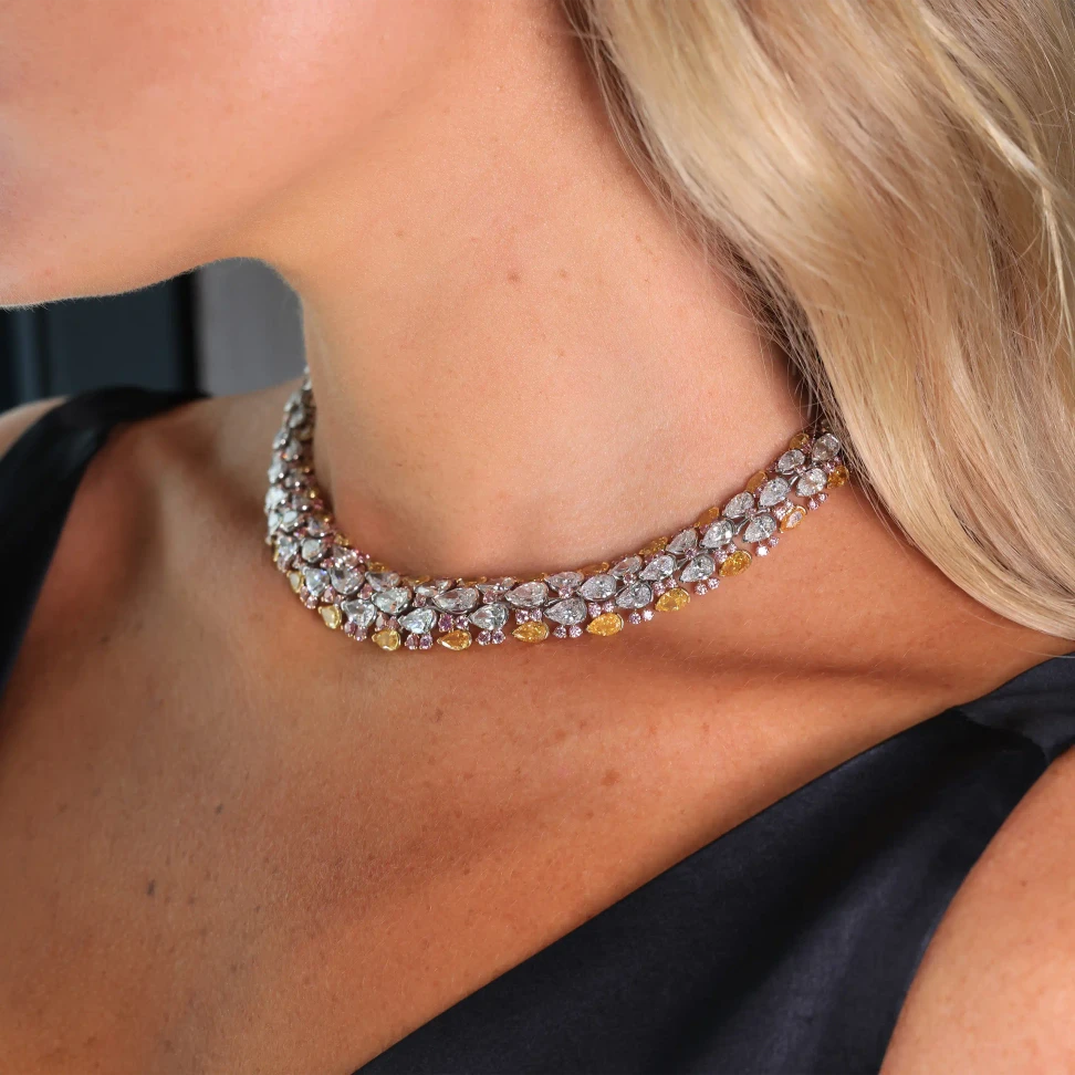 It combines 43.83 carats of pear-shaped white diamonds with fancy orangey yellow and pink diamonds in a fluid, sculptural design