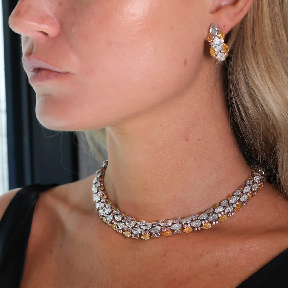 David Morris pairs pear-shaped white and fancy orangey yellow diamonds with flashes of fancy pink in the Samsara earrings