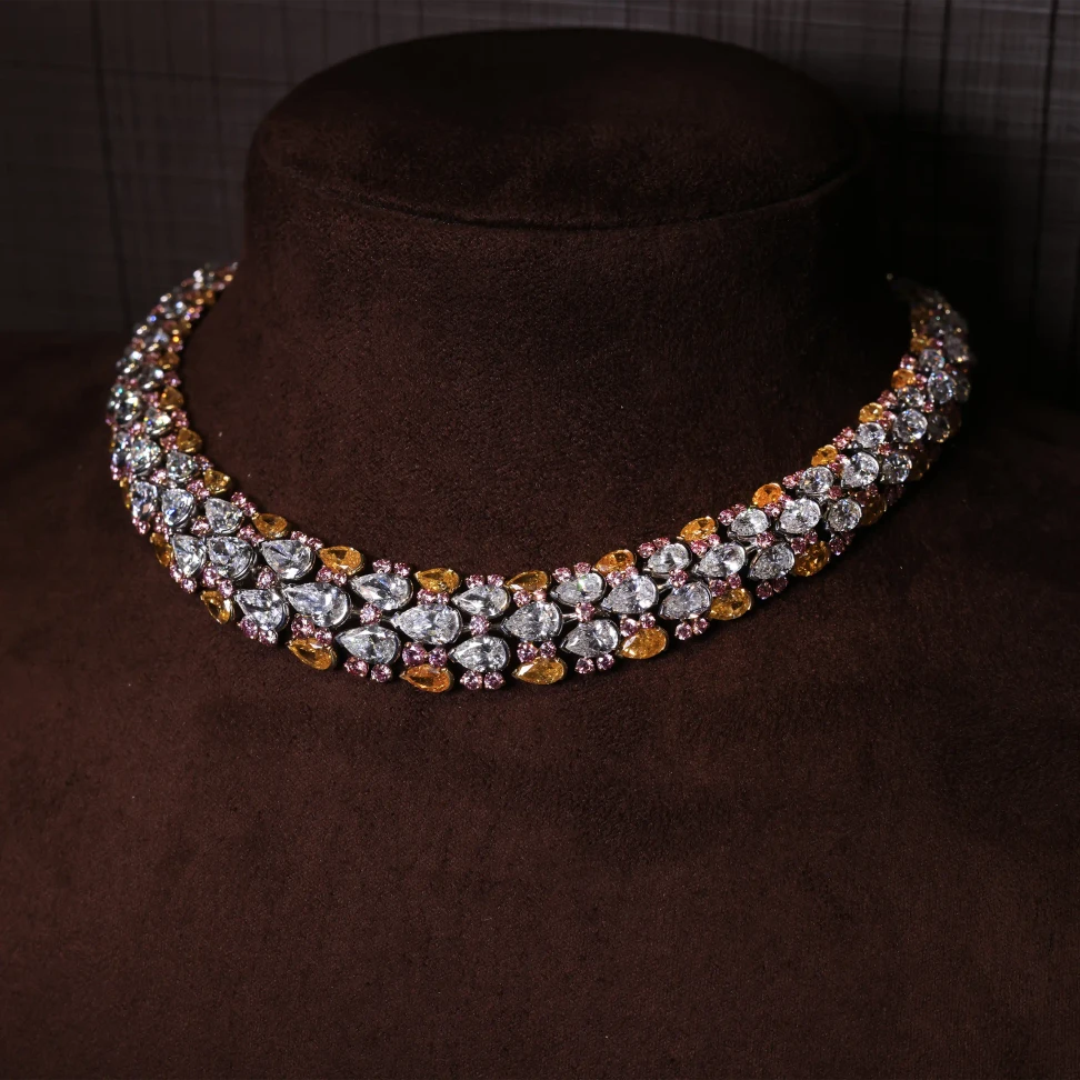 The Samsara necklace features a sunset palette of orangey yellow and pink diamonds