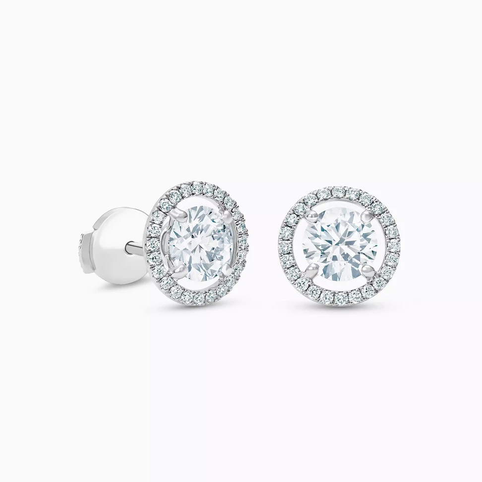 <p>De Beers Aura round brilliant diamond studs</p>
