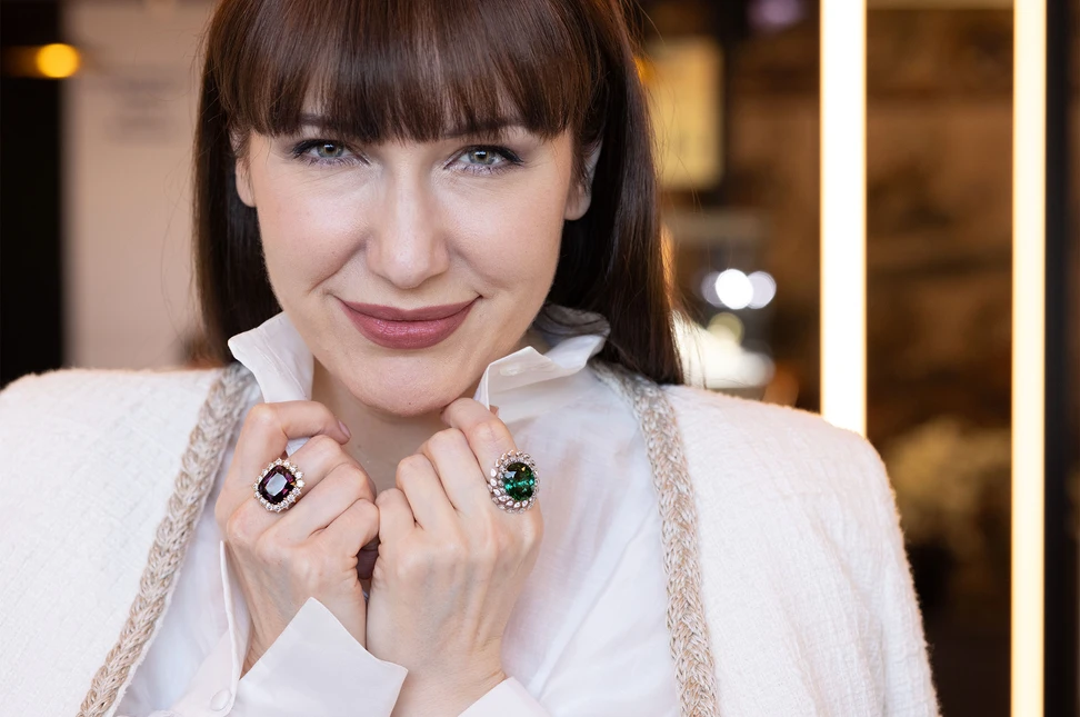 Katerina Perez wears statement coloured gemstone rings by Giorgio Visconti, including a spinel and diamond ring (left) and a tourmaline and diamond ring