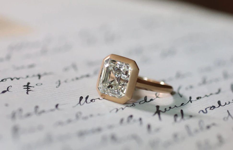 <p>Hancocks 5.06 carat Asscher cut diamond engagement ring in a brushed rose gold setting</p>
