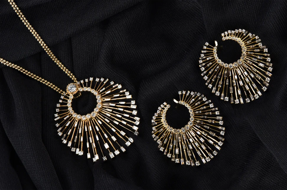 HARAKH Sunlight Luminous Rays medallion necklace with two carats of diamonds set in 18k yellow gold, shown here alongside a matching pair of earrings
