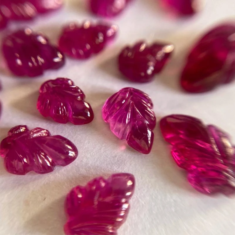 <p>A selection of Minehaus rubies, carved into leaf forms</p>