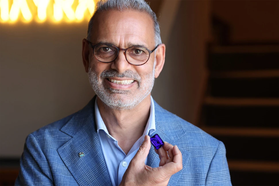 <p>Hayrat Fine Gems co-founder, Zaheer Ansari, holding a spectacular tanzanite</p>
