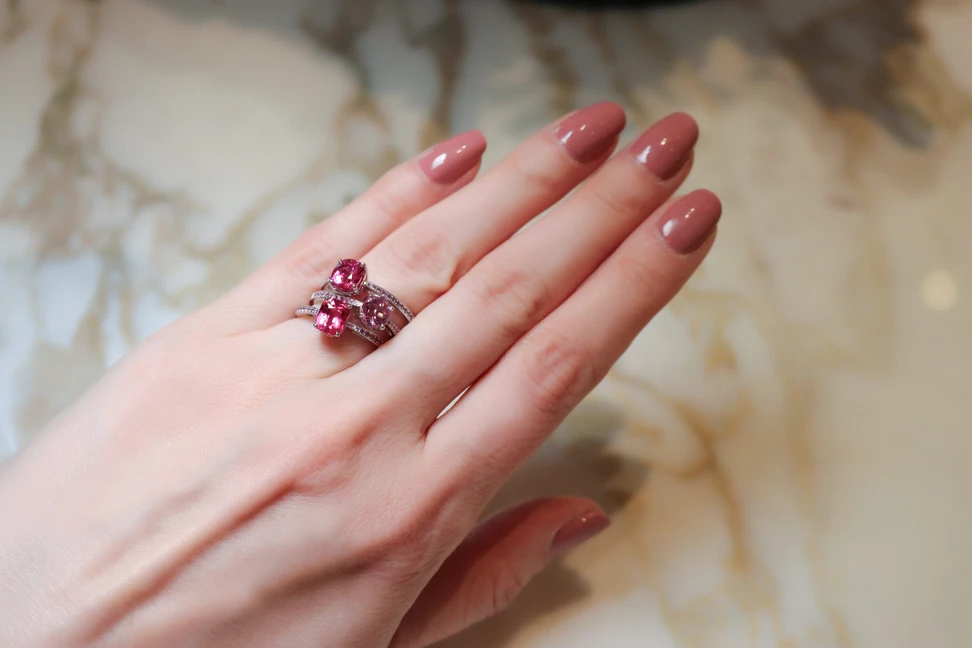 <p>Katerina Perez wears spinel solitaire rings in shades of red and pink from the House of Gübelin </p>
