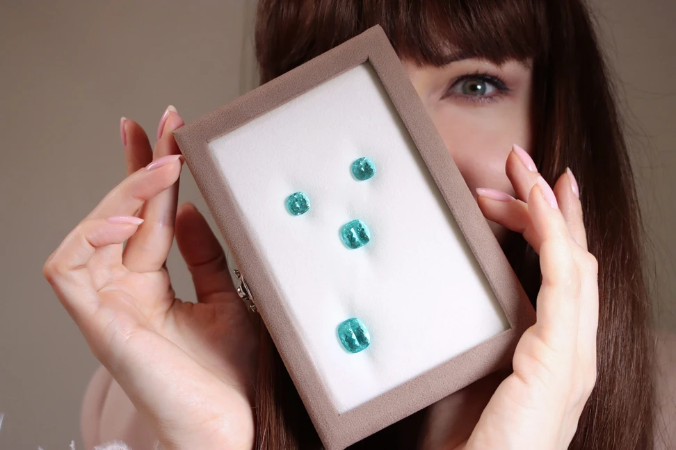 <p>Katerina Perez admires a selection of Paraiba tourmalines presented by Brasil Gem Commerce in Hong Kong</p>