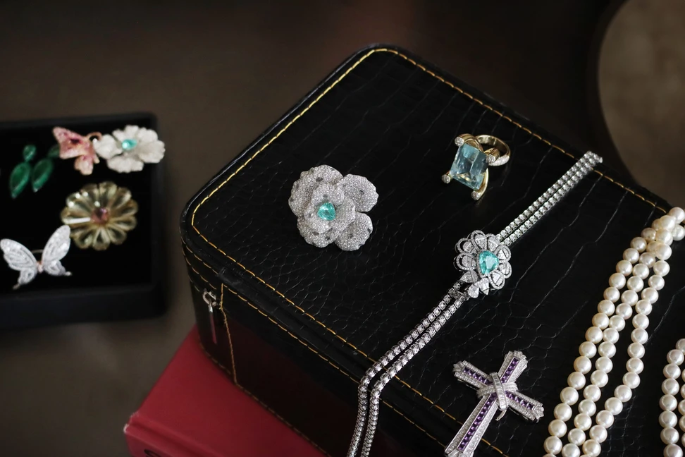 <p>PHERES Paraiba tourmaline and diamond floral ring alongside other bespoke jewels by Narcisa Pheres</p>