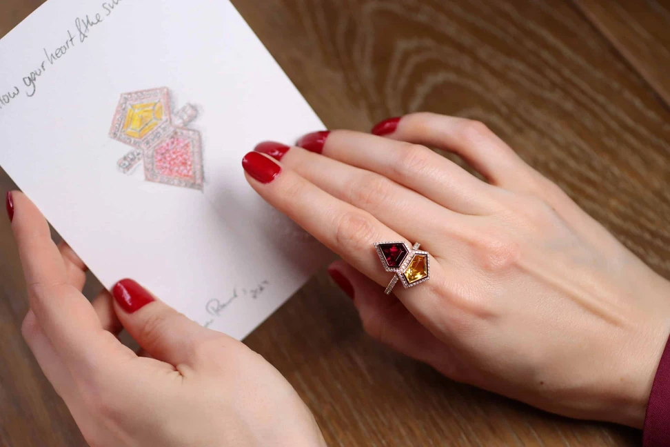 <p>Katerina Perez wears her bespoke Superwoman ring by Sabine Roemer alongside a drawing of the ring in the design stage</p>