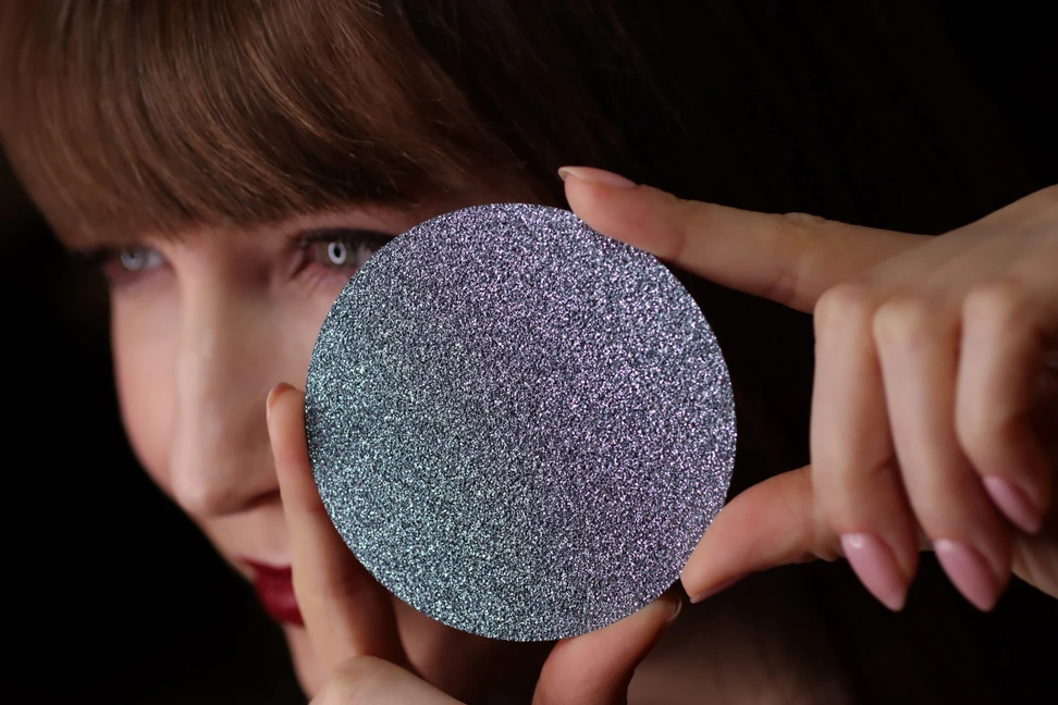 <p>Katerina Perez showcases a large disc of crystalline osmium &#8211; the rarest precious metal on earth</p>
