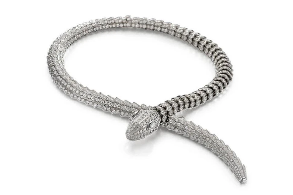 A High Jewelry Serpenti necklace by Bulgari, showcasing 18-karat white gold, pavé diamonds and pear-shaped emerald eyes in the maison's signature serpent design.