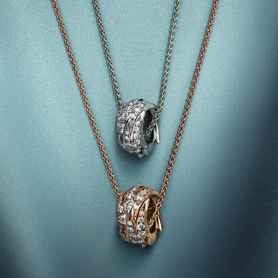 <p>Bird on a Rock by Tiffany Wings rolo pendants in platinum and 18k rose gold with diamonds</p>