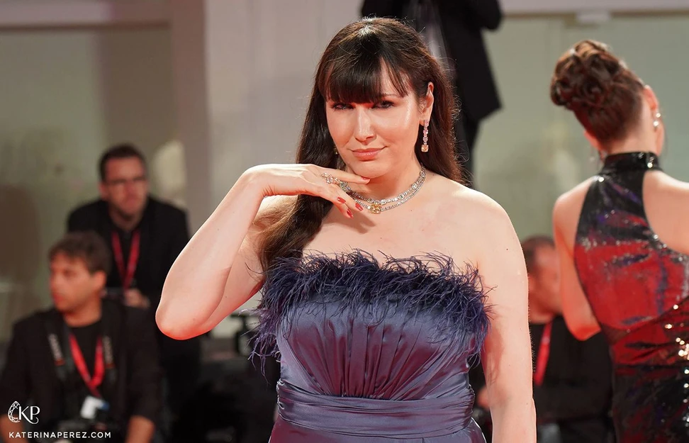 <p>Katerina Perez on the red carpet at the Venice Film Festival 2022 wearing wearing a dress by Sima Couture dress and Hassanzadeh jewellery</p>