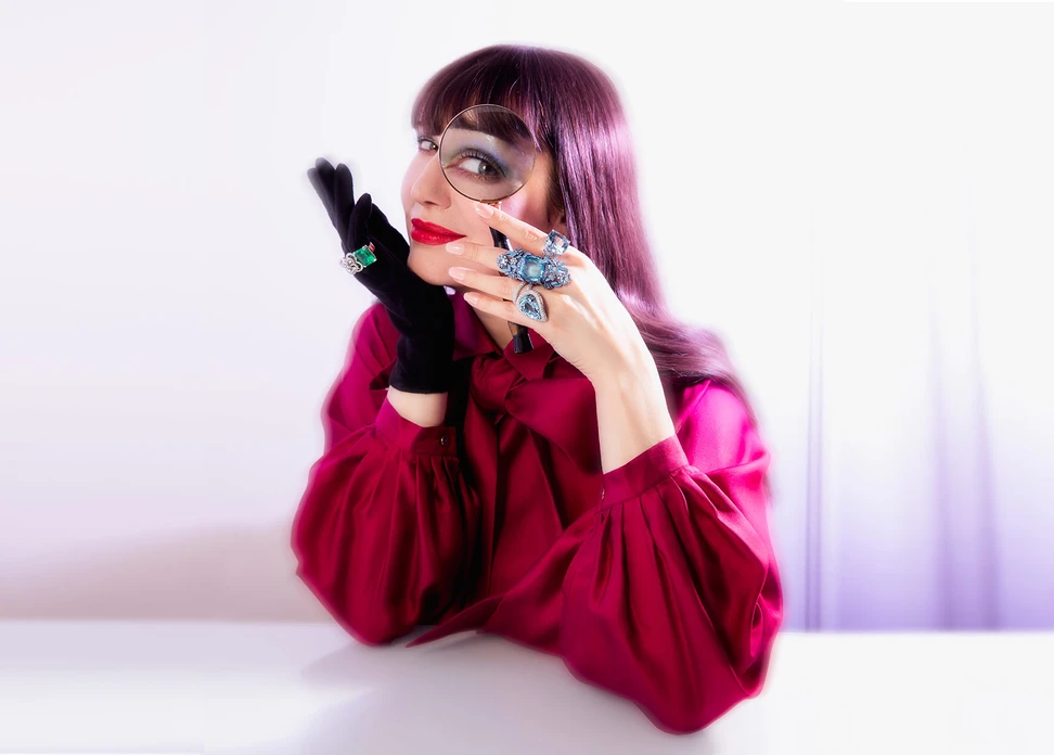 <p>Lydia Courteille aquamarine ring (top), Lydia Courteille Marie Antoinette ring in 18k white gold with 125 sapphires of 5.55 carat, three aquamarines, and blue enamel (middle), Brigitte Ermel TOSCA ring with 2.67 carats of diamonds and a 15.36 carat pear-cut aquamarine in white gold (bottom), plus a Brigitte Ermel 8 Double ring (gloved hand) with a 12.85-carat emerald-cut emerald and diamonds in white gold</p>
