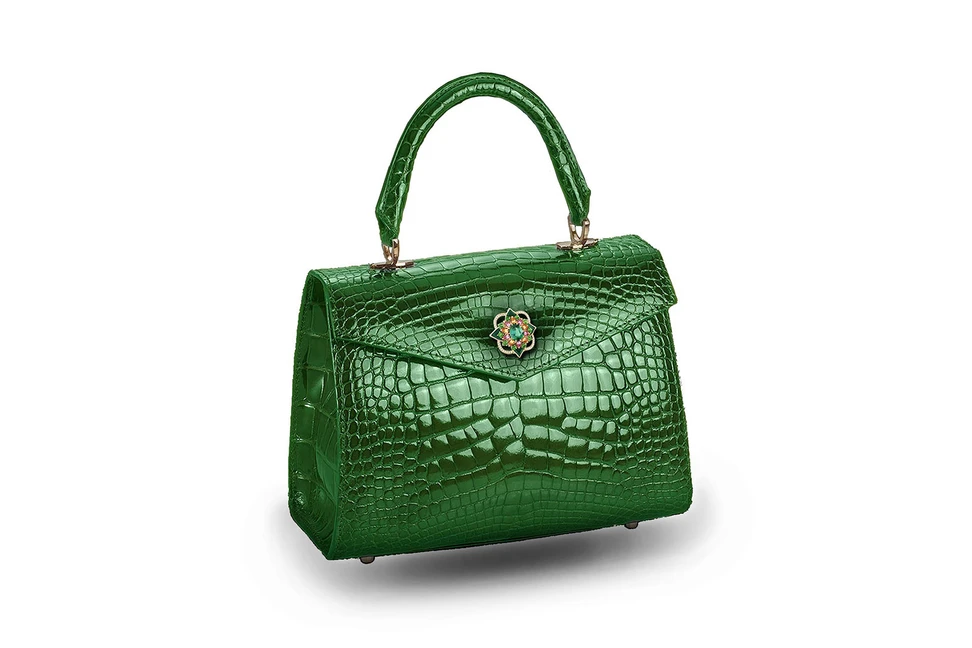 <p>Mellerio dits Meller and Ethan Koh ‘Alla’ bag with the ‘Giardino’ brooch from ‘Isola Madre’ collection in tourmaline, tsavorite, pink sapphire, spessartite garnets, diamonds and green enamel</p>