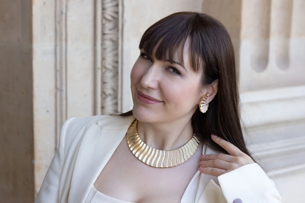 <p>Katerina Perez wears the Messika Mirage necklace crafted with pavé diamond relief in brushed yellow gold alongside the matching earrings, both from the Terres d’Instinct High Jewellery collection</p>