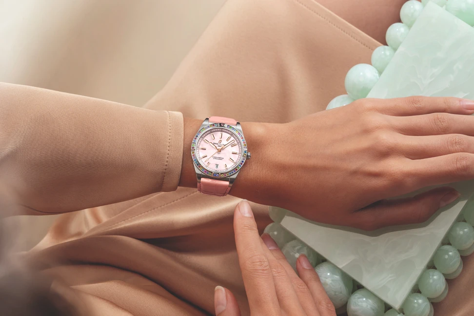 <p>Model wearing Breitling Chronomat Automatic 36 South Sea watch in stainless steel, white gold, mother-of-pearl, multicoloured gemstones and diamond</p>