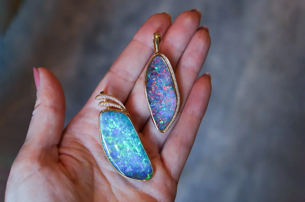 Australian boulder opals ablaze with colour in two one-of-a-kind Olivia Chan pendants: 65.23 carat (left) and 31.58 carat (right) gems, set in 18k yellow gold with diamonds