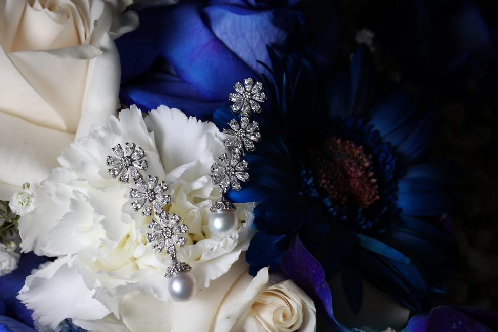 <p>A pair of floral drop earrings by Pearl Biography, set with diamonds and two lustrous white pearls</p>
