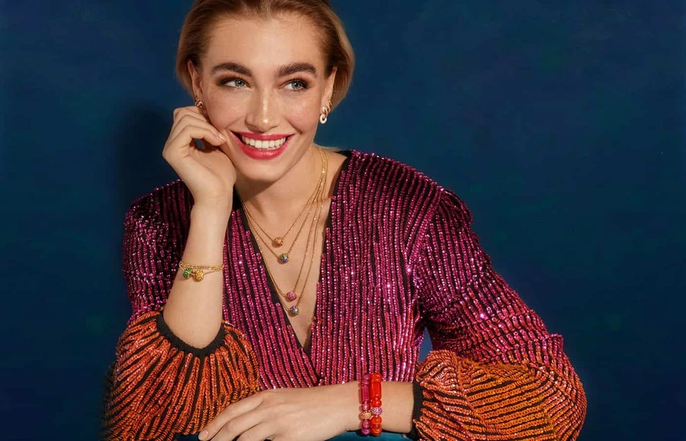 <p>A model wears colourful fine jewellery by Robinson Pelham</p>