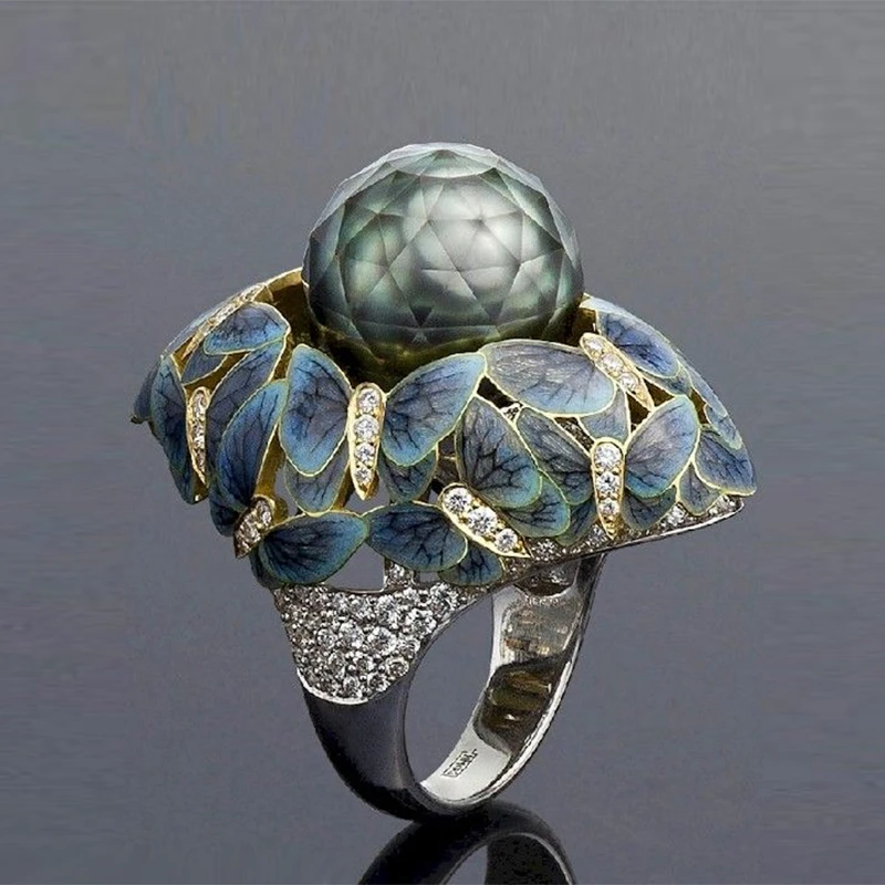 <p>Faceted pearls appear to float among butterflies in this Ilgiz F ring and earrings, winning him the Champion of Champions award</p>