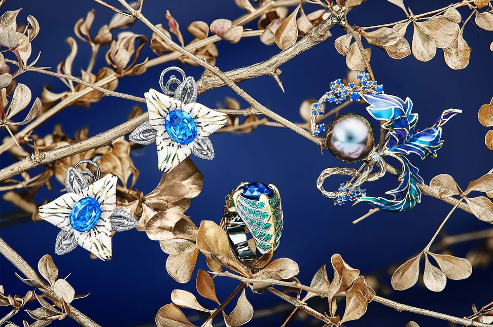 <p>IDORO creations including the Lilies earrings with Ceylon sapphires, diamonds, cold enamel and rhodium in 18k white gold, the Dragon Eye ring with a blue sapphire, emeralds and black rhodium in 18k white gold, and the Vine brooch with a Tahitian pearl, sapphires, rhodium-plated gold and cold enamel</p>
