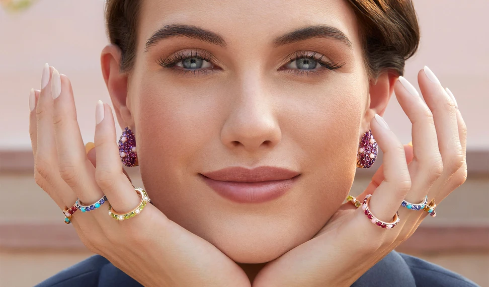 <p>A model wears coloured gemstone rings and earrings from the Jaipur collection by Gyan Jaipur</p>
