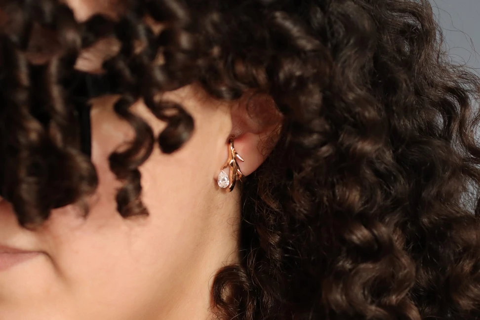 <p>Wrapping elegantly around the lobe, Dalal Alosaimi wears the Kefah earrings in 18k yellow gold with pear shape diamonds by Moody Jewellery</p>