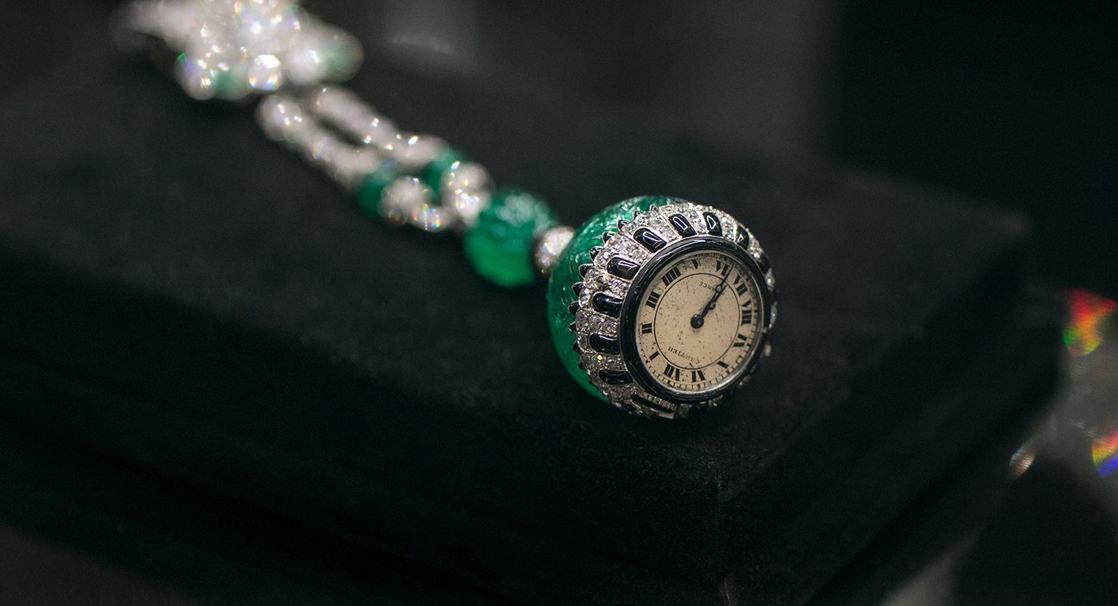 Christie’s auction Cartier lapel watch with emerald, diamond, onyx and enamel