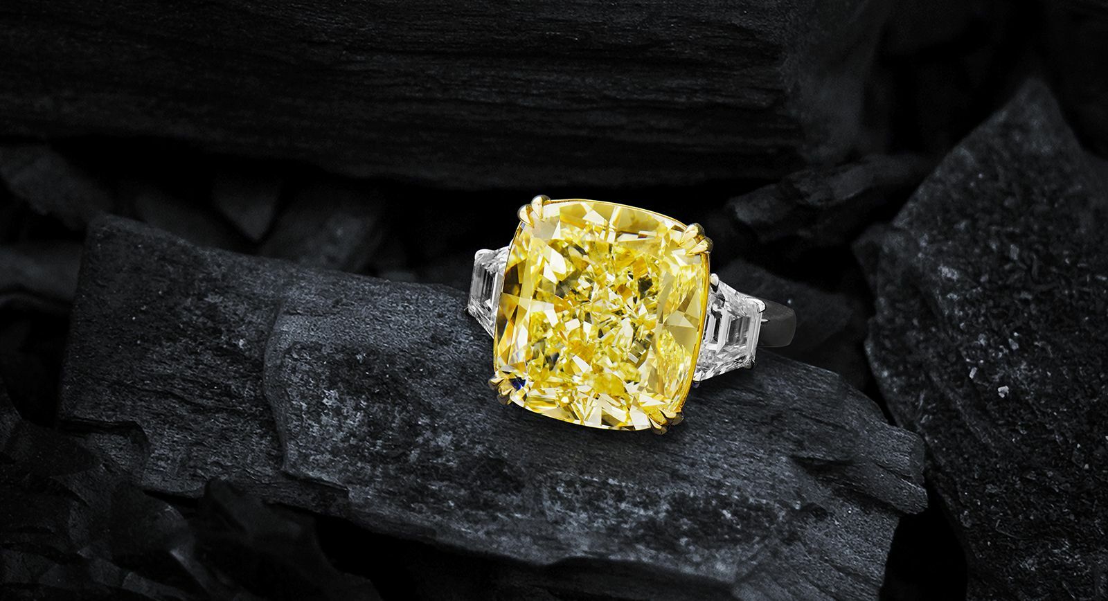Astteria ring with a 15 carat yellow diamond and two trapezoid white diamonds 