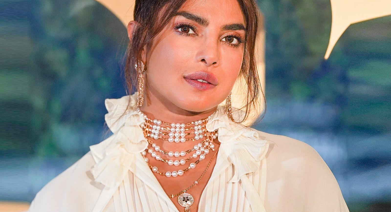 Actress Priyanka Chopra demonstrates the 'neck mess' trend in pearls and yellow gold 
