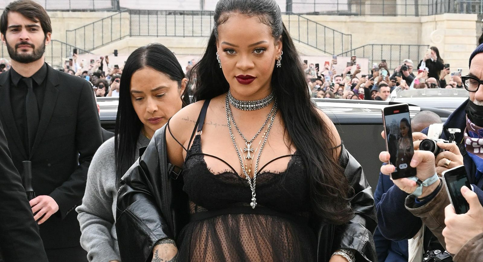 Rihanna at the Dior Fall/Winter 2022/2023 at Paris Fashion Week wearing layered jewellery 