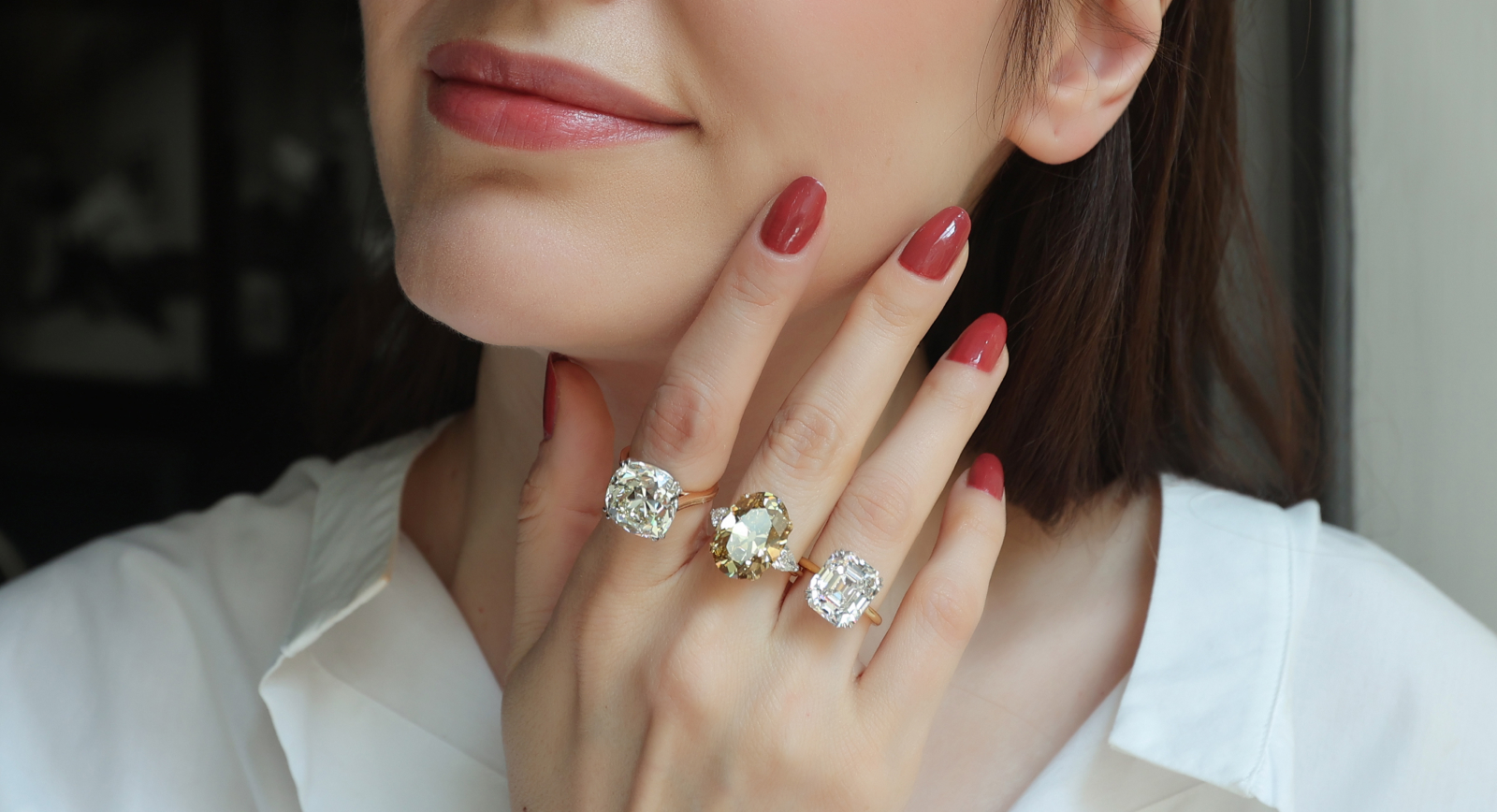 Katerina Perez wearing a selection of Antique rings at Hancocks including a 13.06-ct Old Mine Cushion-cut diamond Solitaire ring, an11.15-ct Fancy Deep colour Old-cut oval diamond ring, and a 9.01-ct Asscher-cut diamond Solitaire ring