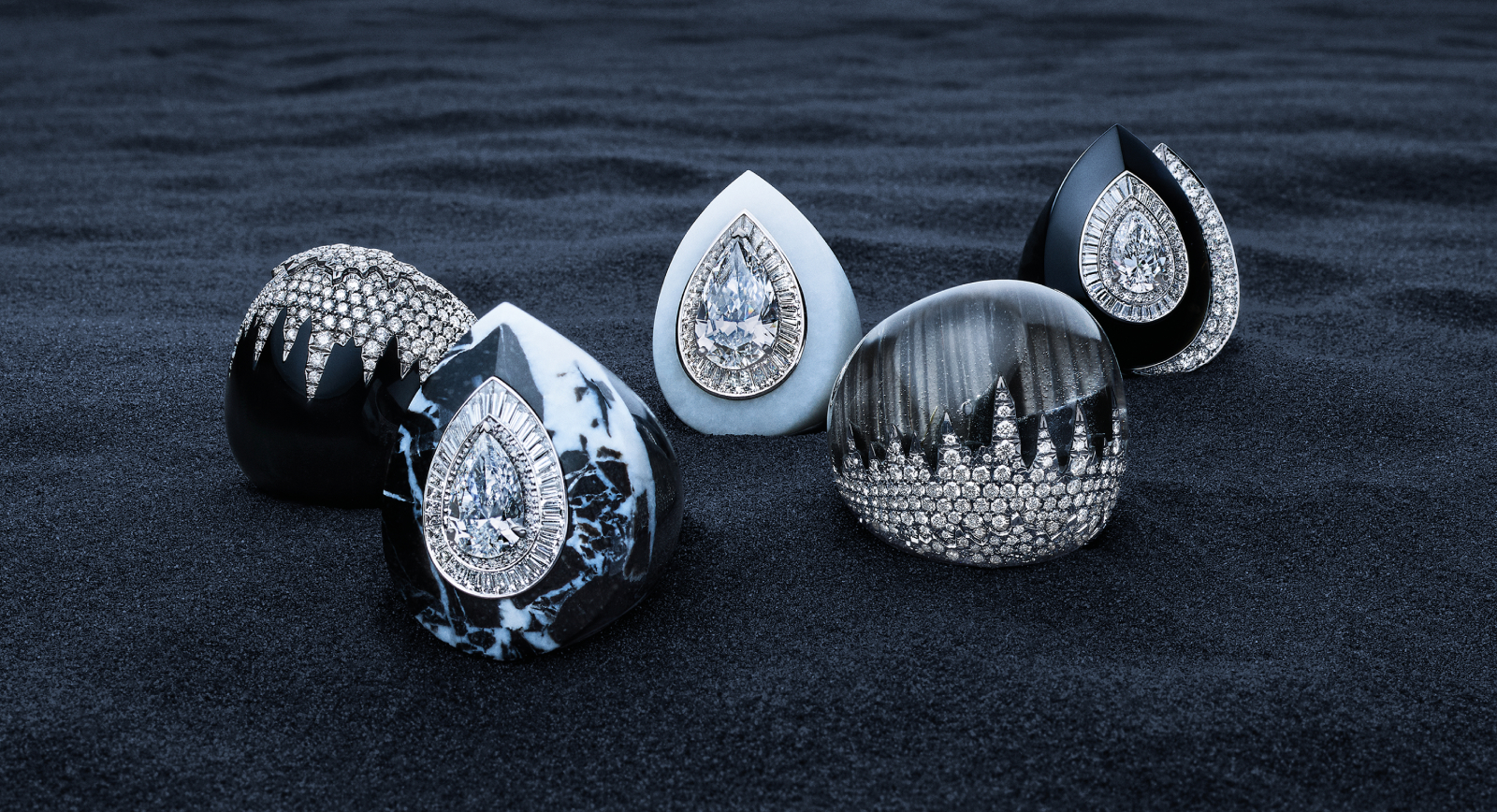 Boucheron Écume rings from the Or Bleu High Jewellery collection, including one with a 5.08 carat D-colour, internally flawless pear-shaped diamond in white jade (centre)