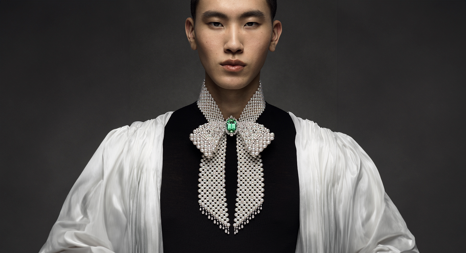 A model wears a Mikimoto necklace with Akoya cultured pearls, round brilliant-cut diamonds, fancy-cut diamonds and a large sea-green tourmaline from ‘The Bows’ High Jewellery collection