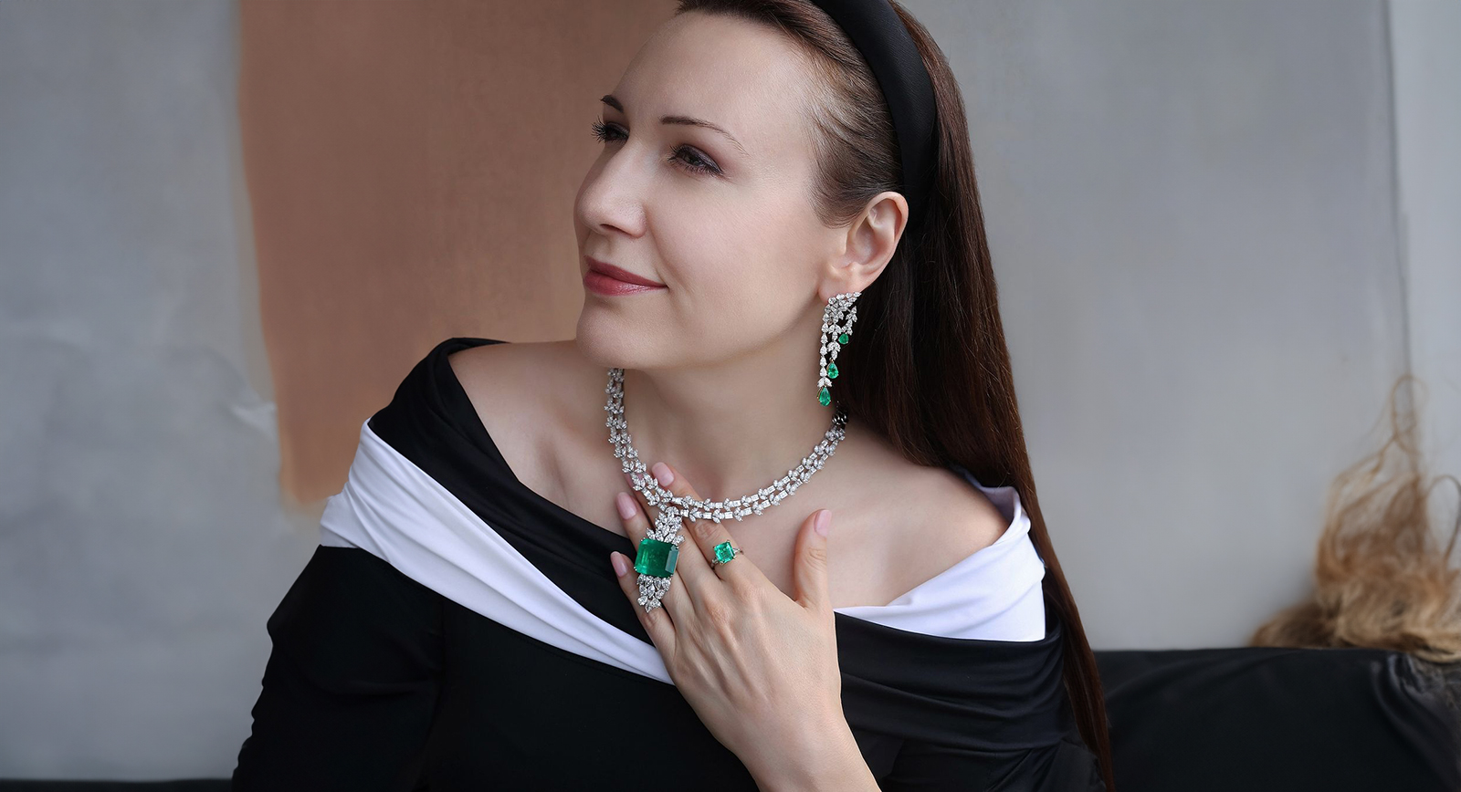 Katerina Perez wears the Emerald Luminaire earrings, Green Royale necklace and the Enchanted Emerald ring by Hassanzadeh Jewellery