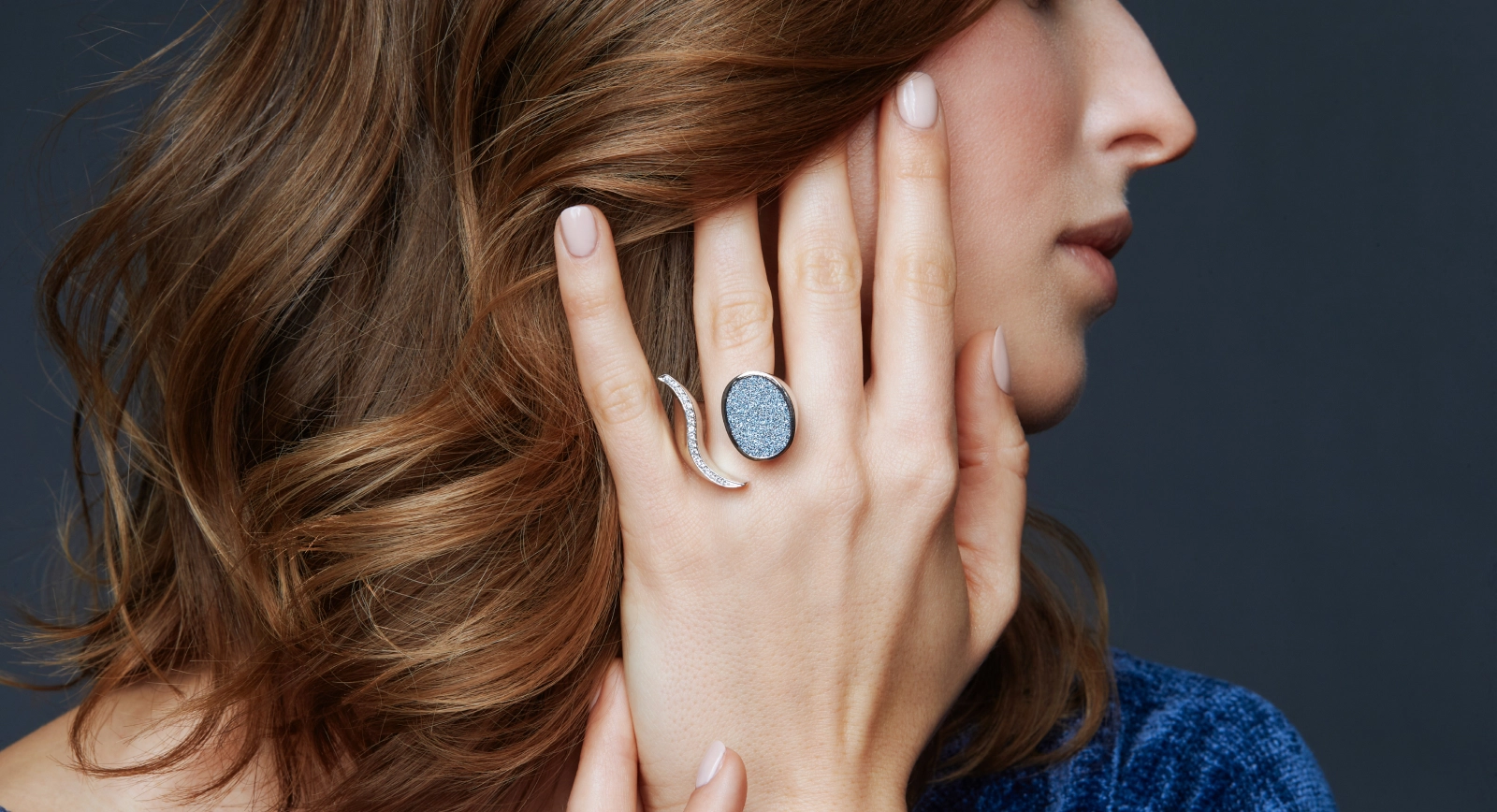 A model wears a ring with an oval-shaped osmium inlay, courtesy of the Osmium Institute 