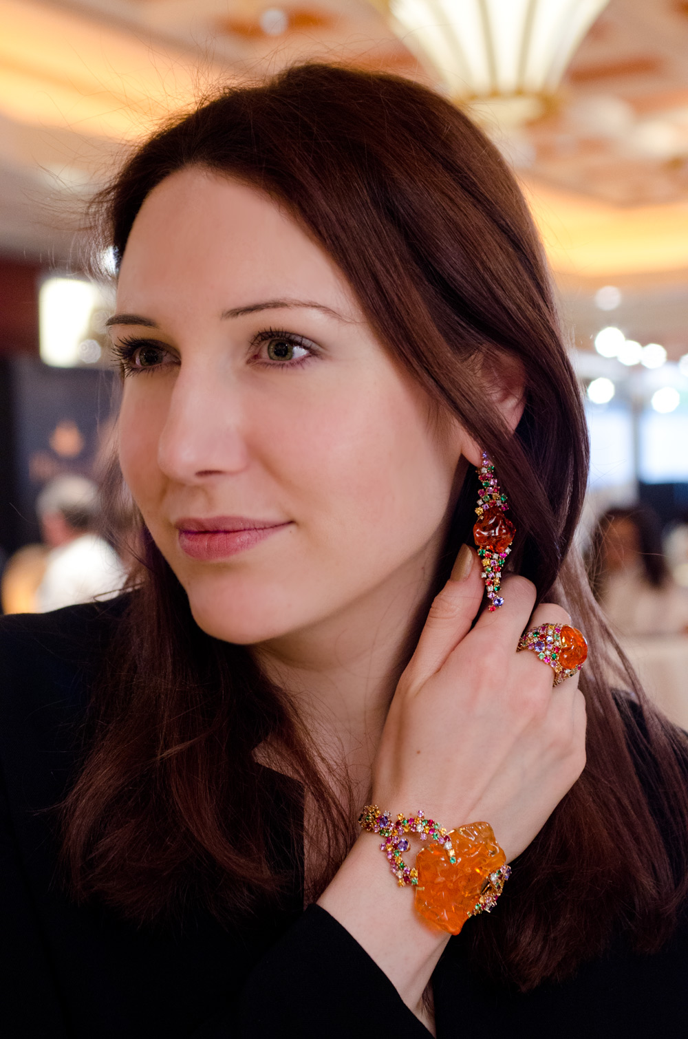 Katerina Perez wearing Mauro Felter Path of Flowers jewellery set with fire opals