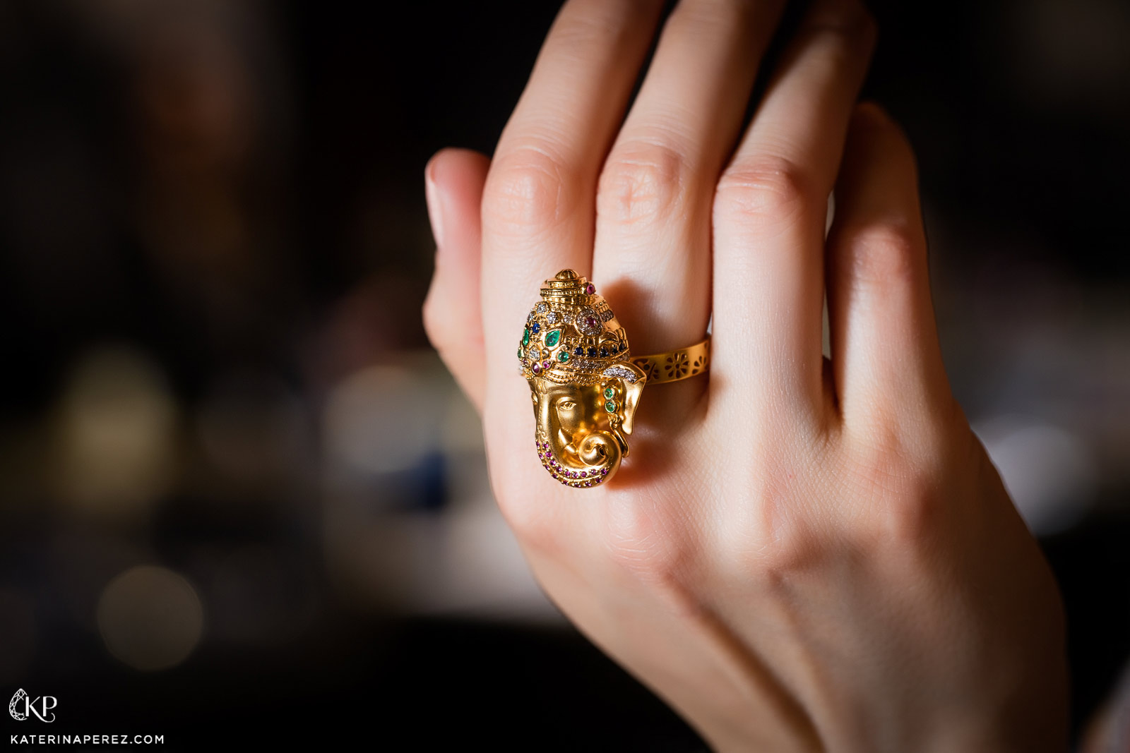 Buddha Mama Ganesh ring in yellow gold with coloured gemstones and diamonds.  Photo by Simon Martner
