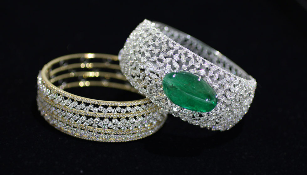 Bapalal Keshavlal bracelets in white and yellow gold with diamonds and an emerald cabochon
