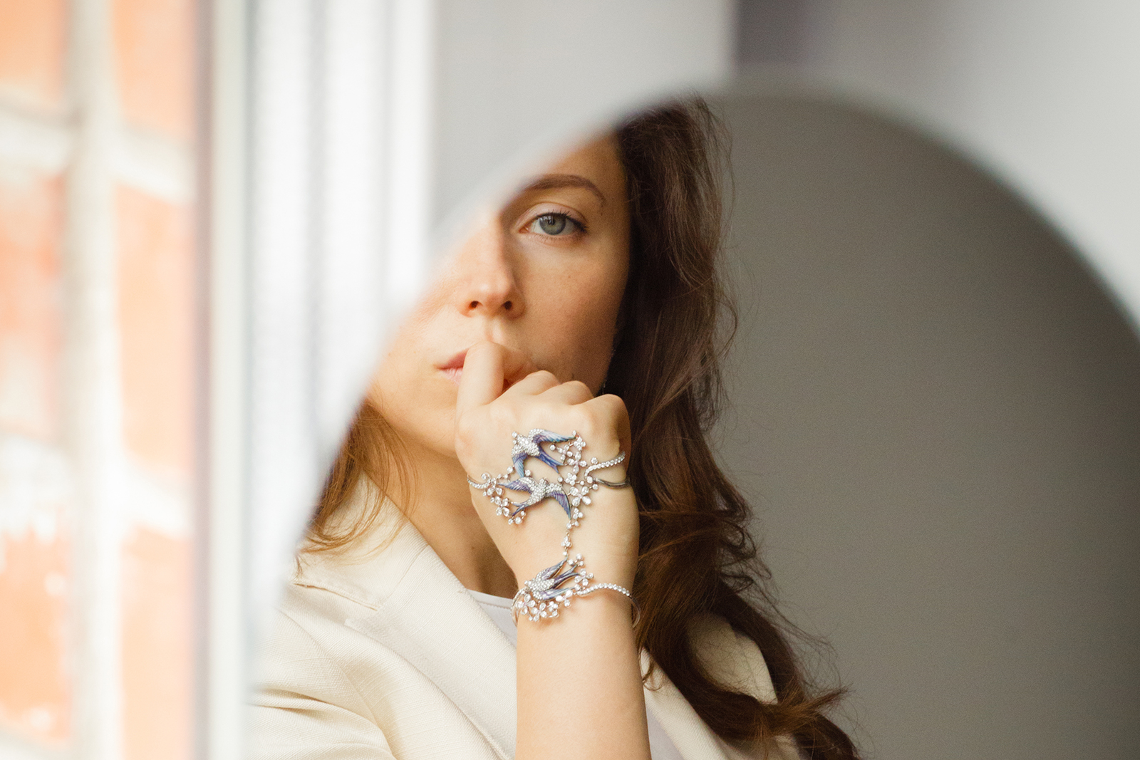 Elizaveta Borzunova, founder of Liza Borzaya in her enamel and diamond 'Swallow' palm bracelet